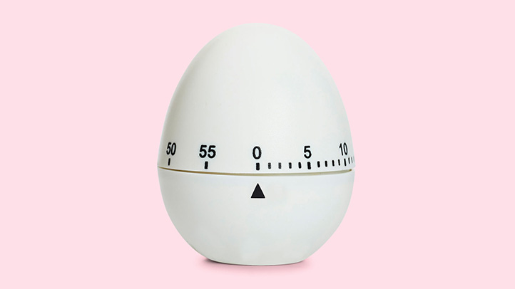 Close-up shot of an egg timer on pink background