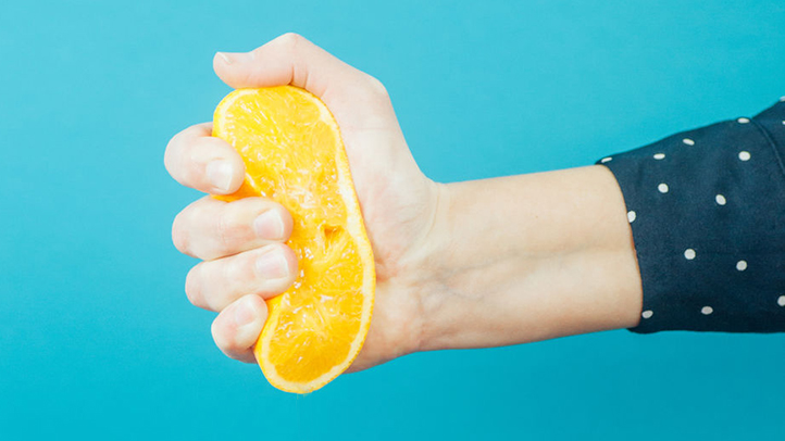 hand squeezing orange, cramps and contractions after sex during pregnancy